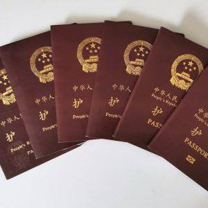 a set of five chinese passports sitting on top of each other